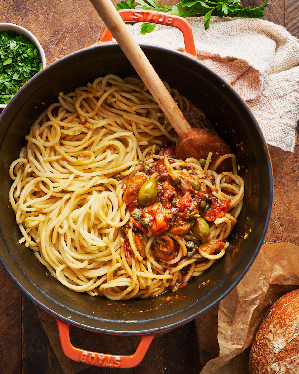 If you're looking for some dinner inspiration, allow me to tempt you with this fresh tomato pasta puttanesca. The tomato based puttanesca sauce is made from pantry staples like anchovy fillets, capers, and black olives. And it gets tossed with al dente pasta (any variety will work) for a classic Italian pasta dish the whole family will enjoy!