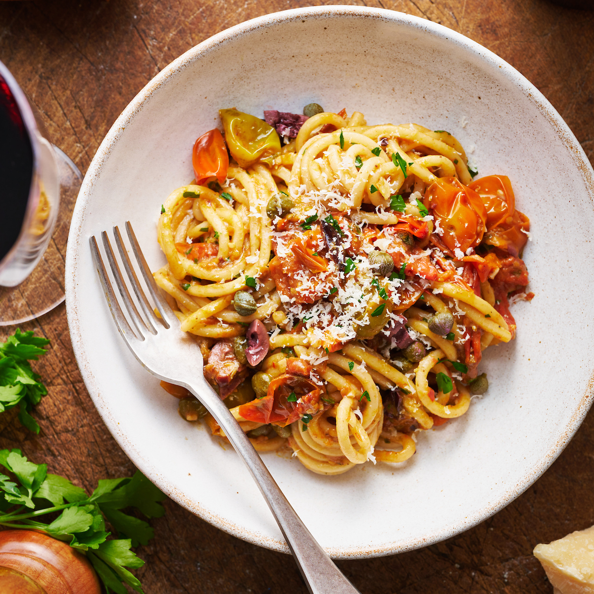 If you're looking for some dinner inspiration, allow me to tempt you with this fresh tomato pasta puttanesca. The tomato based puttanesca sauce is made from pantry staples like anchovy fillets, capers, and black olives. And it gets tossed with al dente pasta (any variety will work) for a classic Italian pasta dish the whole family will enjoy!