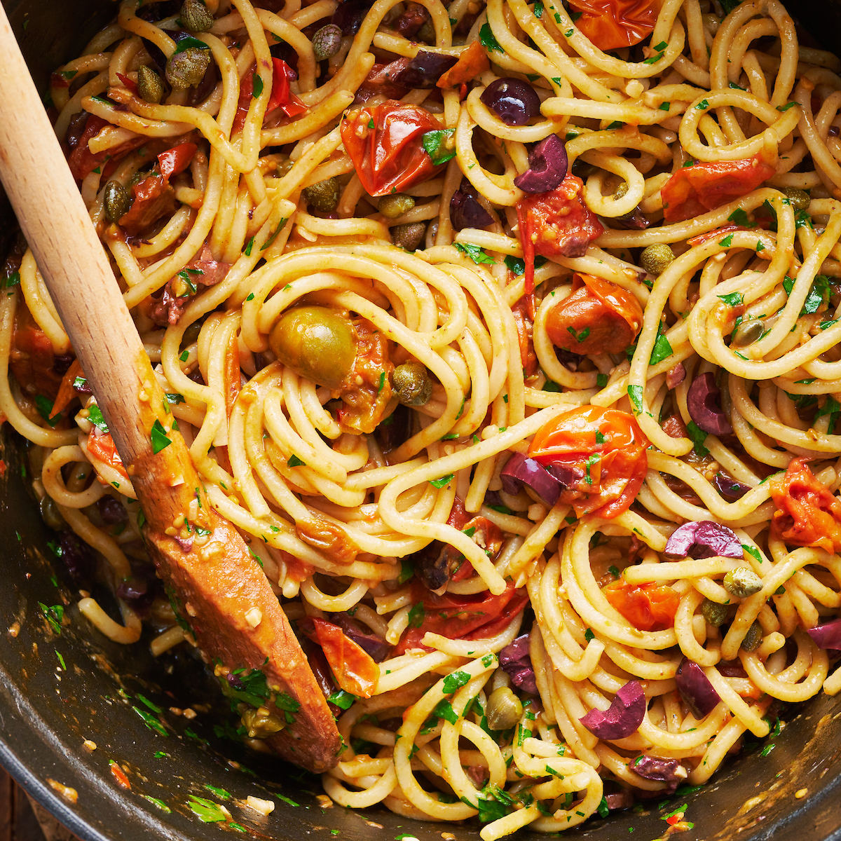 If you're looking for some dinner inspiration, allow me to tempt you with this fresh tomato pasta puttanesca. The tomato based puttanesca sauce is made from pantry staples like anchovy fillets, capers, and black olives. And it gets tossed with al dente pasta (any variety will work) for a classic Italian pasta dish the whole family will enjoy!
