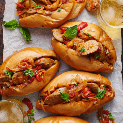 Italian Sausage and Peppers is delicious served with pasta or piled high on a chewy hoagie roll! Loaded with sausage, peppers, and onions and coated in a tangy tomato sauce, this is one of my favorite recipes to make for company! Serves a crowd and can be kept warm in a crockpot or slow cooker.