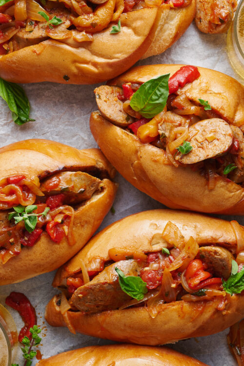 Italian Sausage and Peppers is delicious served with pasta or piled high on a chewy hoagie roll! Loaded with sausage, peppers, and onions and coated in a tangy tomato sauce, this is one of my favorite recipes to make for company! Serves a crowd and can be kept warm in a crockpot or slow cooker.