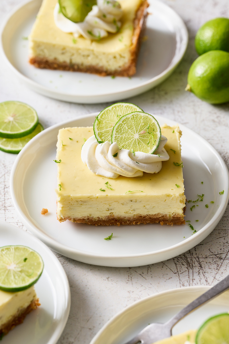 If you like key lime pie and cheesecake, you'll love key lime cheesecake bars! Featuring a crunchy graham cracker crust and a creamy key lime-flavored cheesecake filling, they're just begging to be topped with a dollop of whipped cream. Baked in a 9x13-inch baking pan, these bars easily serve a crowd.