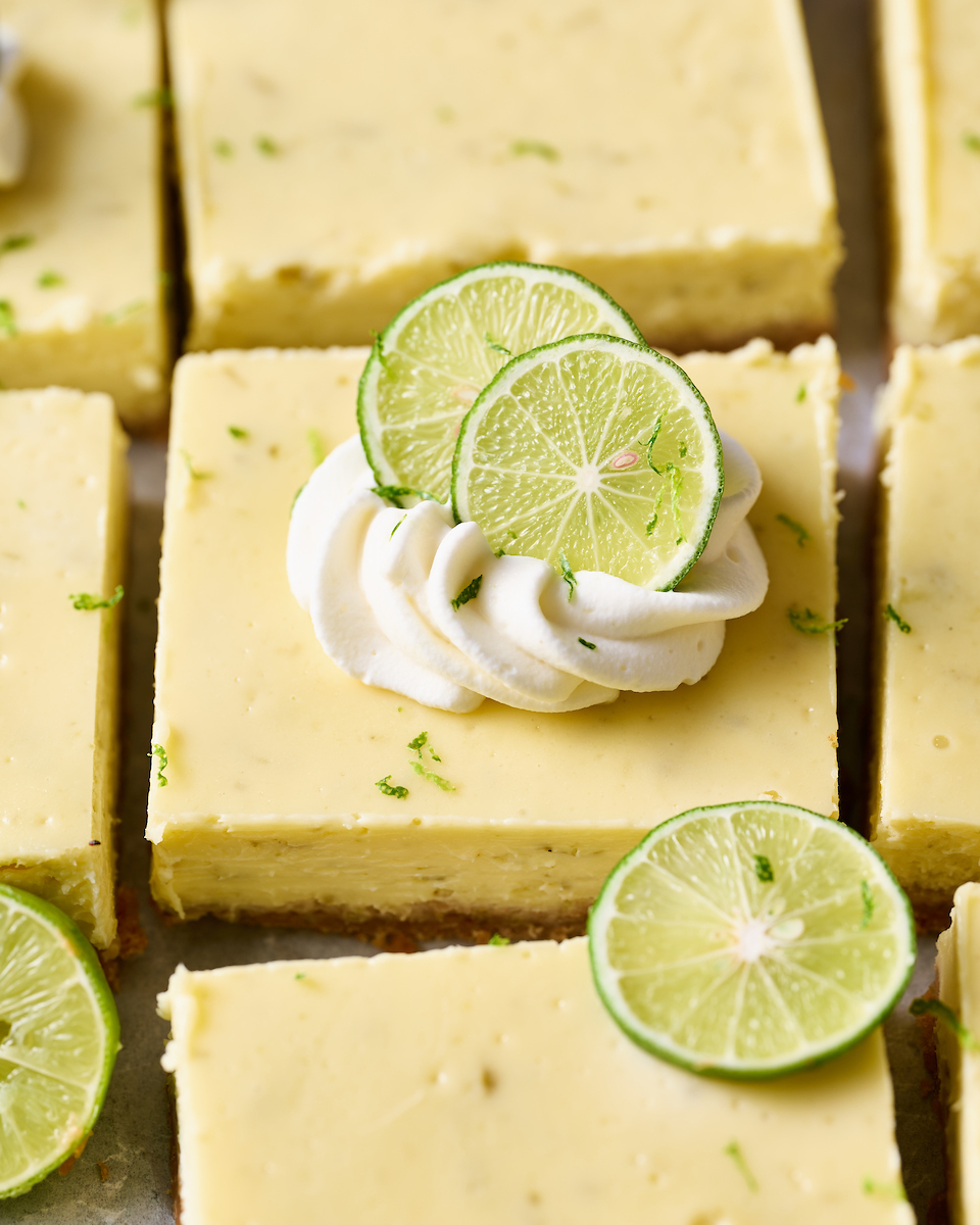 If you like key lime pie and cheesecake, you'll love key lime cheesecake bars! Featuring a crunchy graham cracker crust and a creamy key lime-flavored cheesecake filling, they're just begging to be topped with a dollop of whipped cream. Baked in a 9x13-inch baking pan, these bars easily serve a crowd.