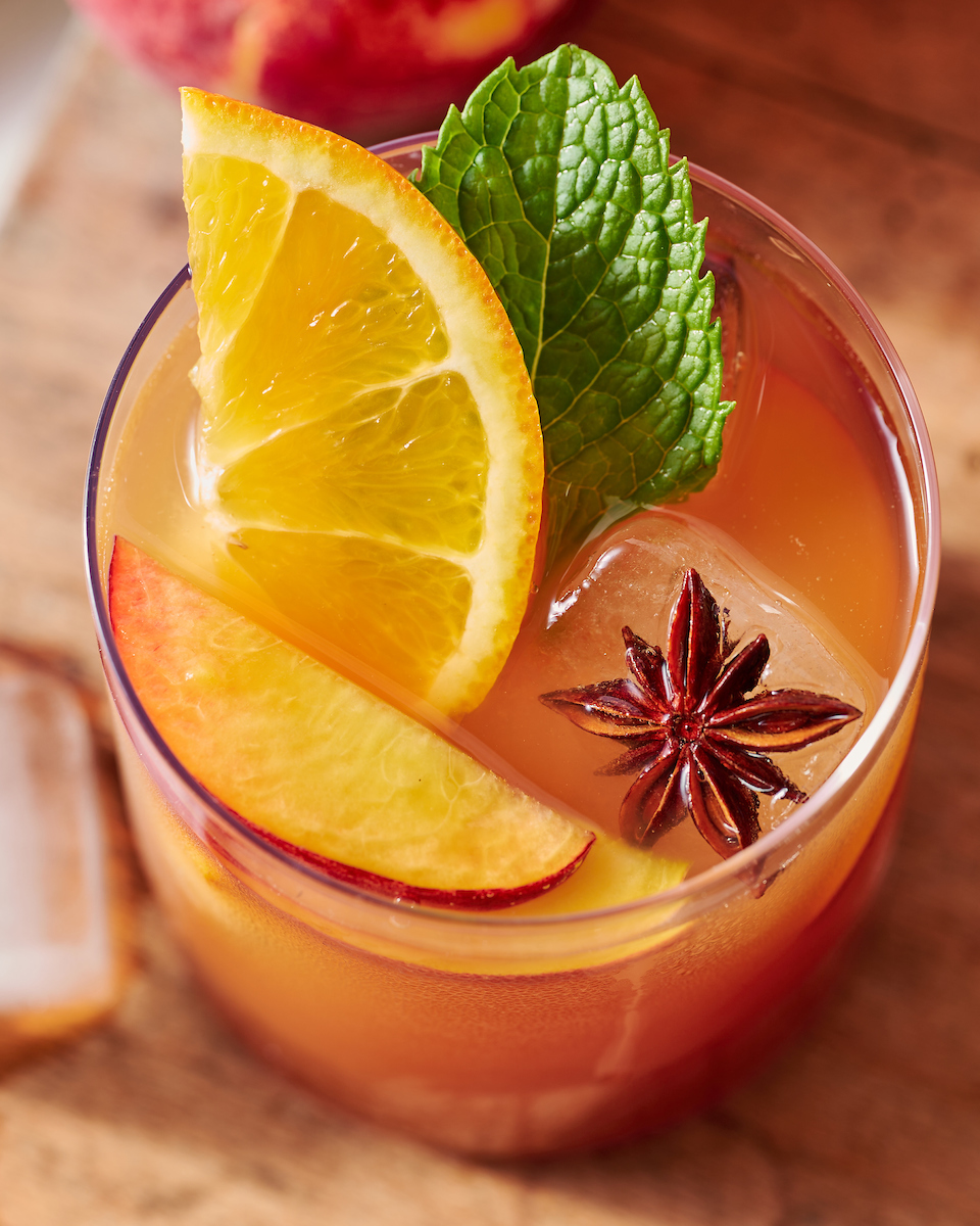 If you're searching for a big batch summer cocktail, look no further than this bourbon spiked peach iced tea! Made with peach nectar, black tea, and fresh peach slices, this recipe is perfect for barbecues, parties, and picnics. Bust out a large pitcher and make a batch today!