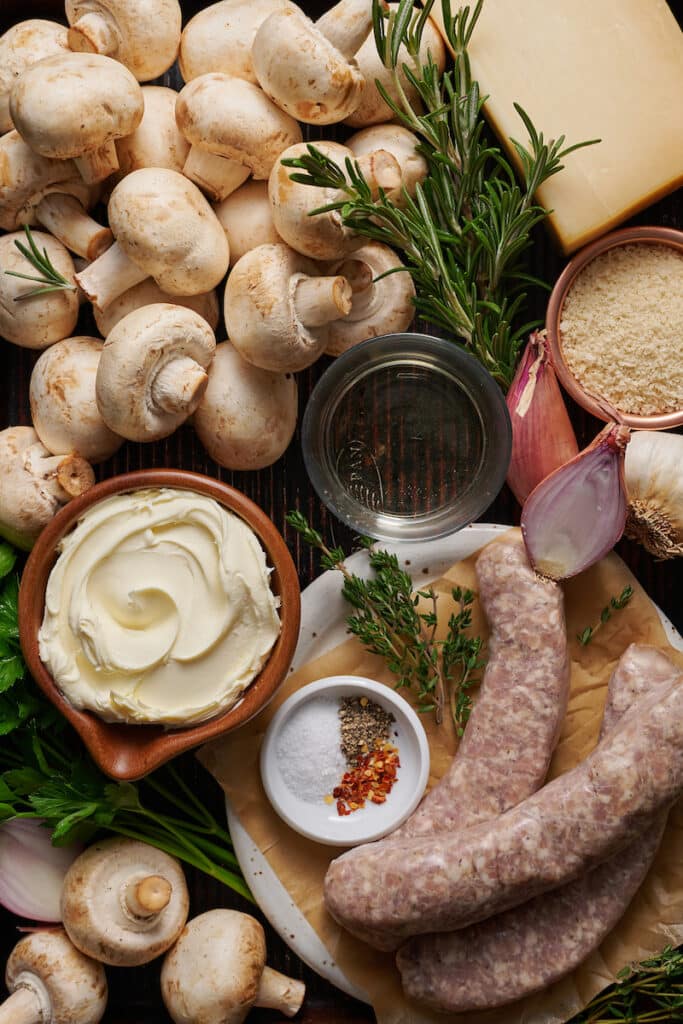 Ingredients for stuffed mushrooms on a baking sheet.