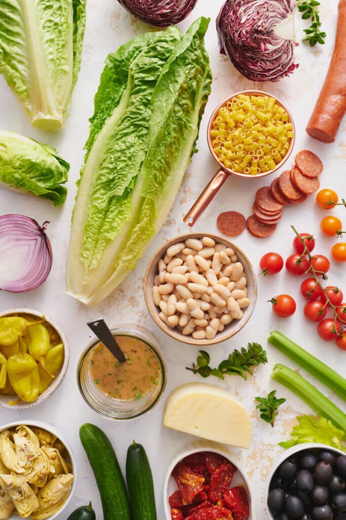 Ingredients for an Italian chopped salad on a table.