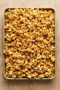 Baked caramel corn on baking sheet.