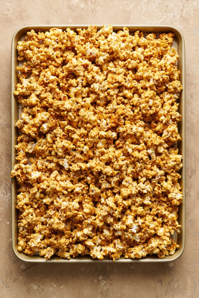 Baked caramel corn on baking sheet.