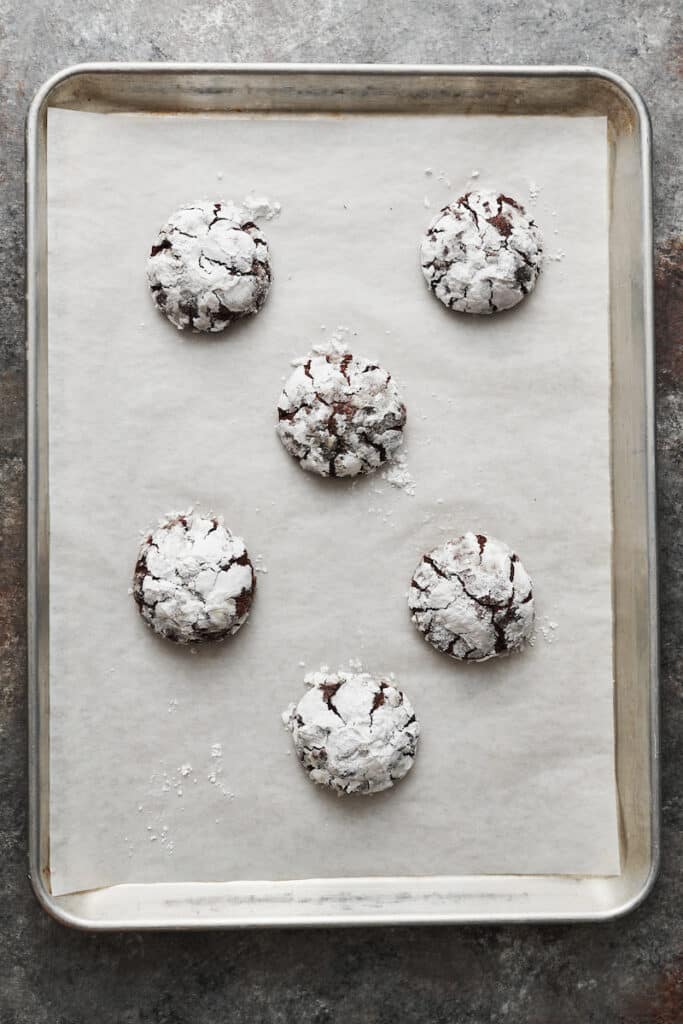 Baked chocolate cookies on baking sheet.