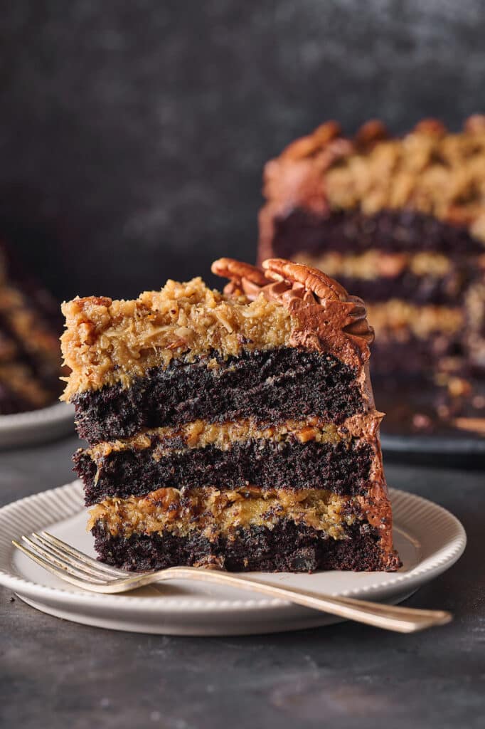 Slice of German Chocolate cake on a plate with fork.