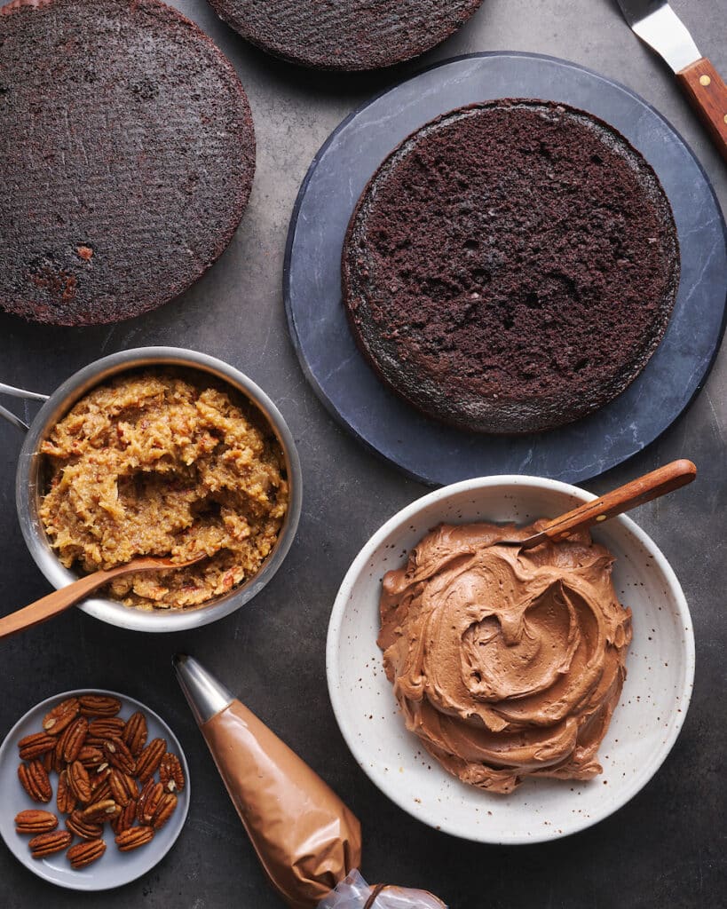 German Chocolate cake layers with coconut pecan frosting and chocolate frosting on the side.