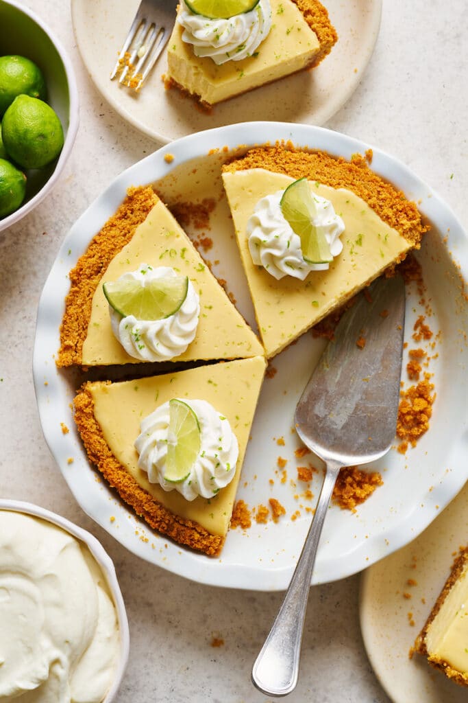 Key lime pie cut into slices in the pie dish.