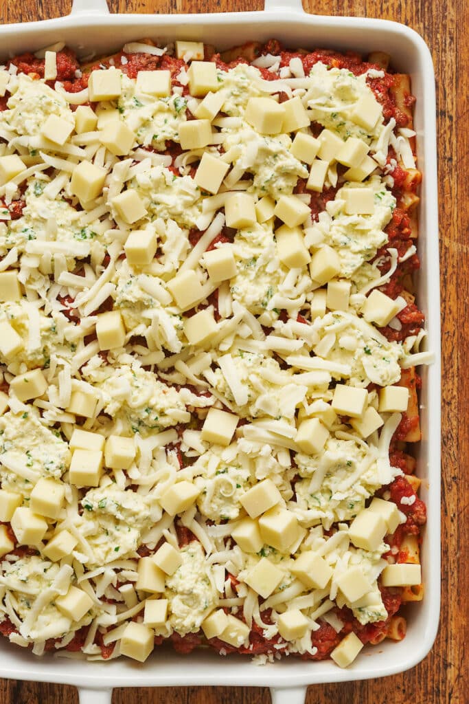Assembled baked ziti in baking dish ready to be baked.