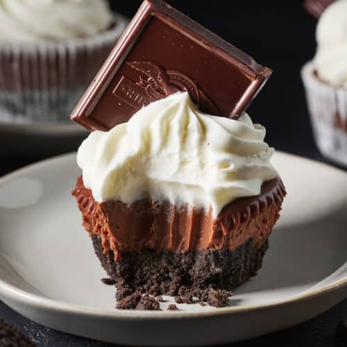 Mini chocolate pie with whipped cream and a chocolate square.
