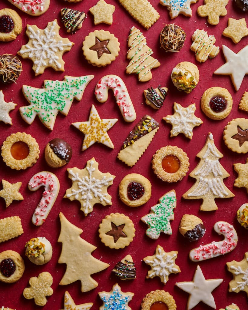 Christmas cookies cut out and decorated with red and green sprinkles.