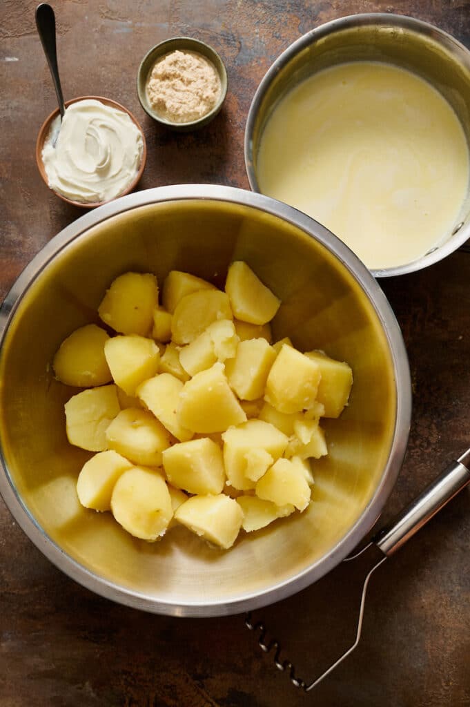 Cut potatoes in a large bowl.