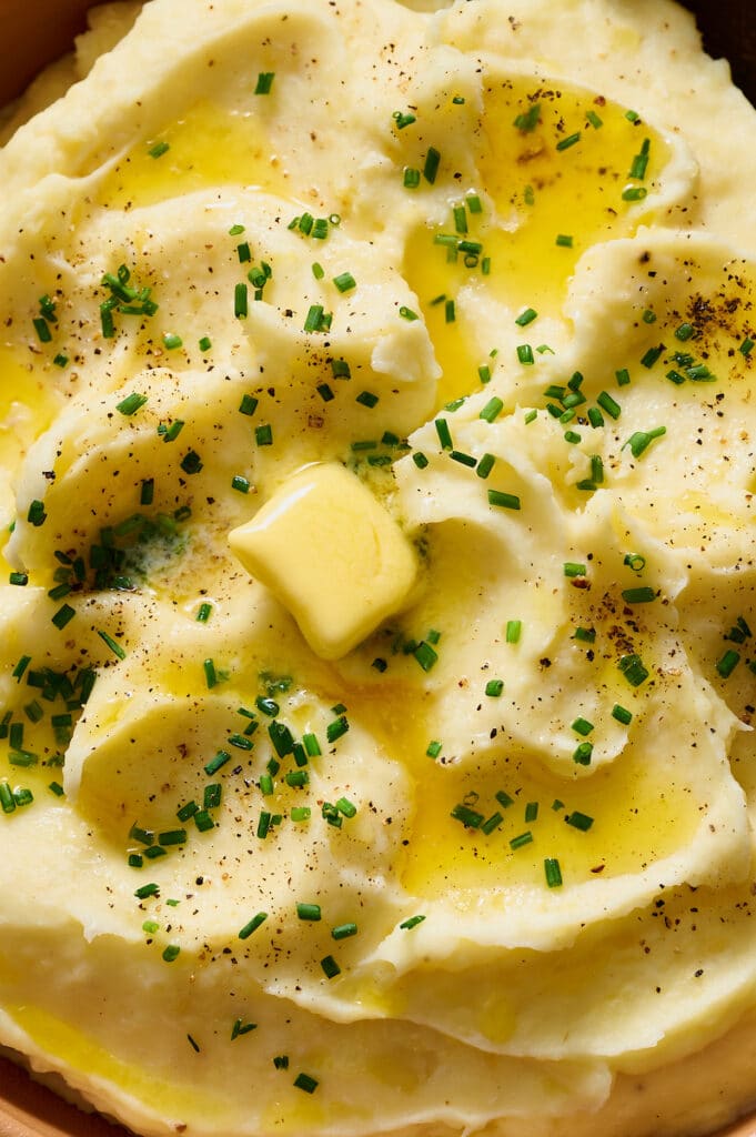 Close up of melted butter on top of potatoes.