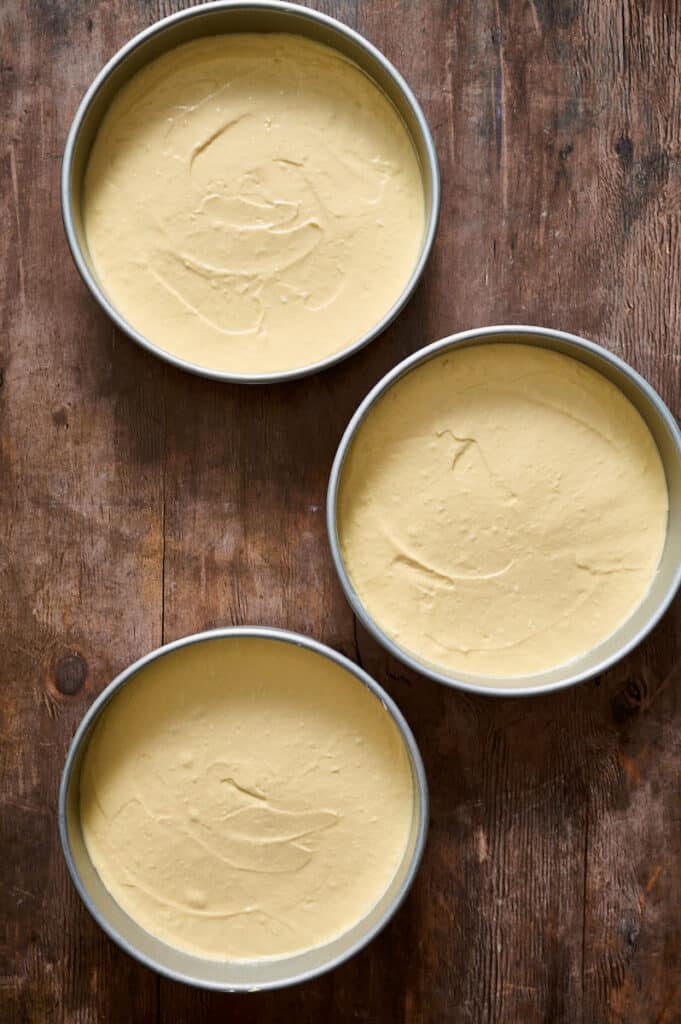 Cake batter in cake pans.