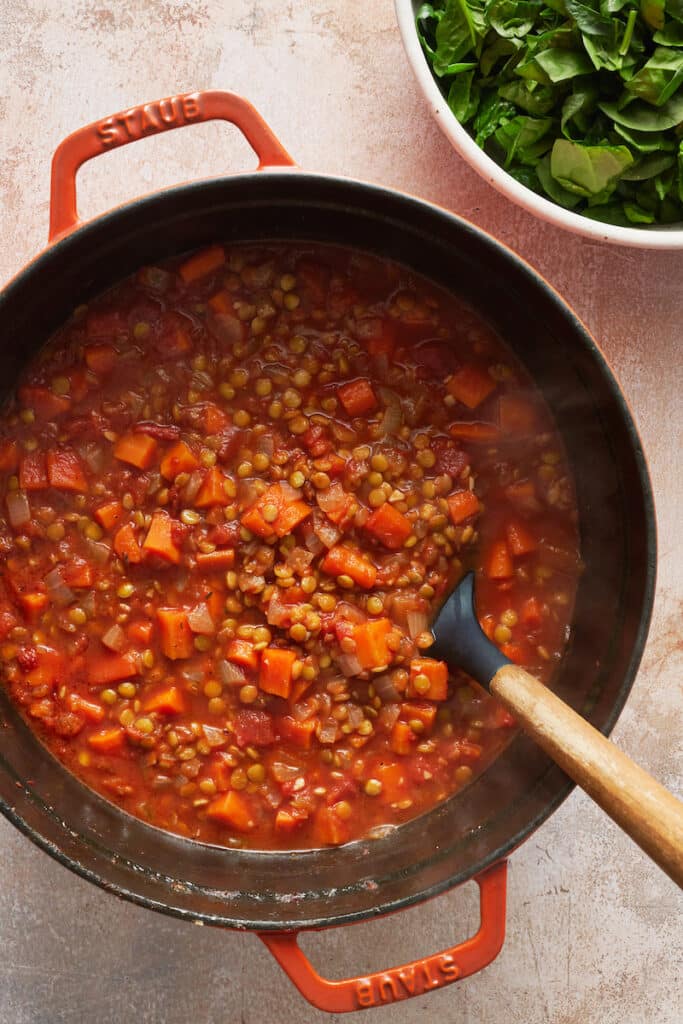 Lentil soup on table in dutch oven.