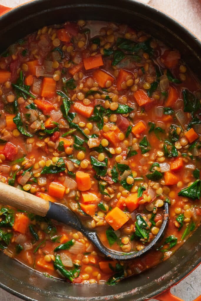 Orange dutch oven with lentil soup.