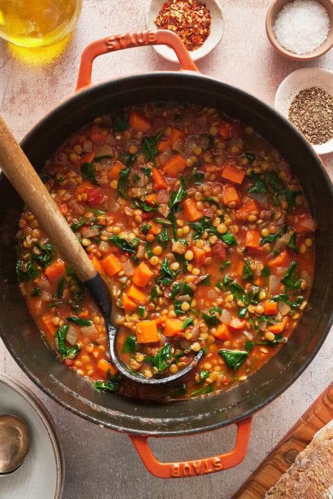 Orange dutch oven with lentil soup.