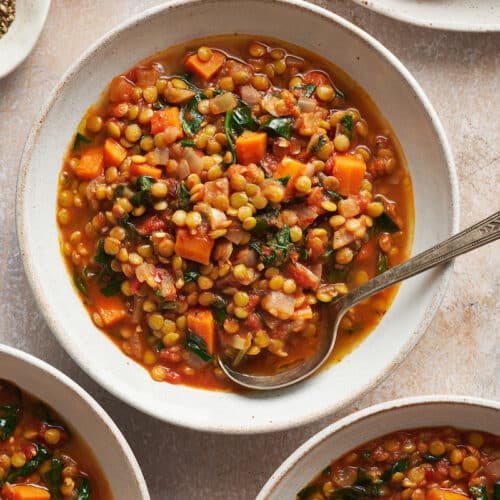 White bowls with lentil soup inside.